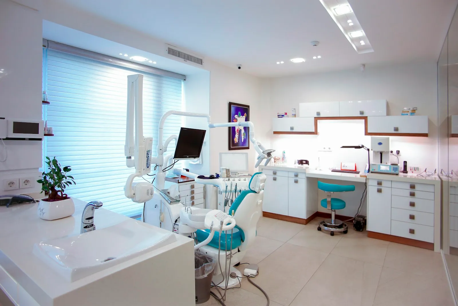 Treatment room with a modern dental chair and monitor