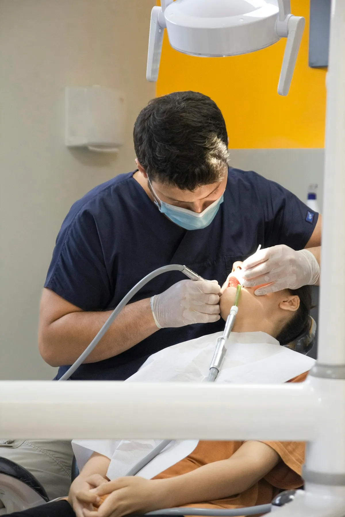 Orthodontist fitting braces on a patient